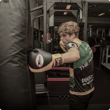 Man hitting heavy bag with boxing glove